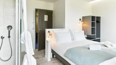 Un ou plusieurs lits dans un hébergement de l'établissement Pavillon de la plage
