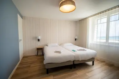 Un ou plusieurs lits dans un hébergement de l'établissement Hôtel de la Baie