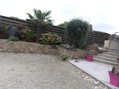 Jardin de l'établissement Appartement plein pied bord de mer