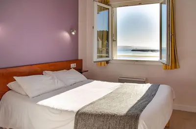 Un ou plusieurs lits dans un hébergement de l'établissement Hôtel & Restaurant de la Plage