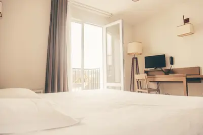 Un ou plusieurs lits dans un hébergement de l'établissement Terres de France - Appart'Hotel Quimper Bretagne