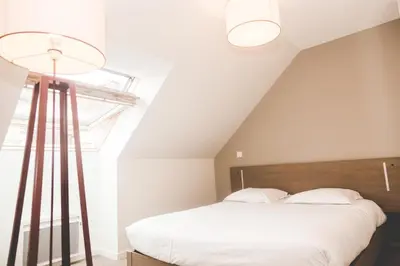 Un ou plusieurs lits dans un hébergement de l'établissement Terres de France - Appart'Hotel Quimper Bretagne