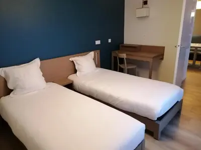 Un ou plusieurs lits dans un hébergement de l'établissement Terres de France - Appart'Hotel Quimper Bretagne
