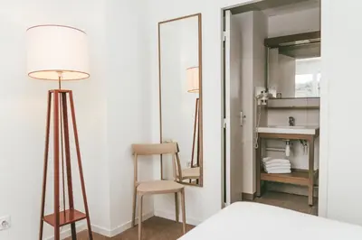 Un ou plusieurs lits dans un hébergement de l'établissement Terres de France - Appart'Hotel Quimper Bretagne