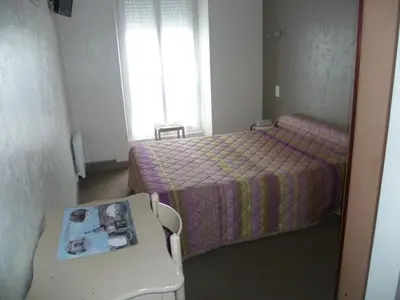 Un ou plusieurs lits dans un hébergement de l'établissement Hotel Du Port