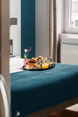 Un ou plusieurs lits dans un hébergement de l'établissement Le Cornouaille Hotel & Spa