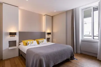 Un ou plusieurs lits dans un hébergement de l'établissement Le Cornouaille Hotel & Spa