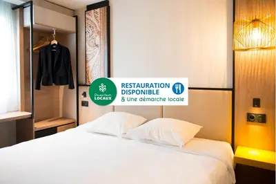 Un ou plusieurs lits dans un hébergement de l'établissement Brit Hotel Brest Le Relecq Kerhuon