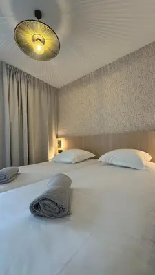 Un ou plusieurs lits dans un hébergement de l'établissement Abalys Hotel