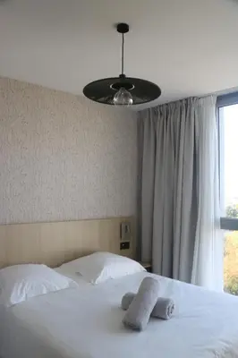 Un ou plusieurs lits dans un hébergement de l'établissement Abalys Hotel