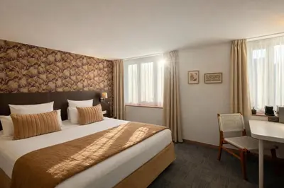 Un ou plusieurs lits dans un hébergement de l'établissement Cit'Hotel Hôtel de France et d'Europe