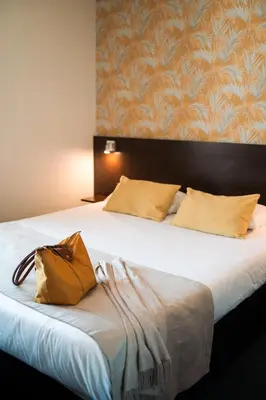 Un ou plusieurs lits dans un hébergement de l'établissement Hôtel Bellevue