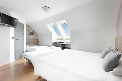 Un ou plusieurs lits dans un hébergement de l'établissement Brit Hotel Iroise Brest