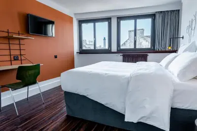Un ou plusieurs lits dans un hébergement de l'établissement Bateau Libre Hotel