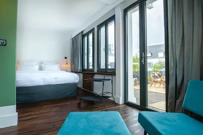 Un ou plusieurs lits dans un hébergement de l'établissement Bateau Libre Hotel