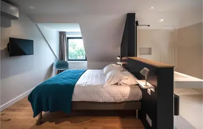 Un ou plusieurs lits dans un hébergement de l'établissement Lovely Apartment In Concarneau