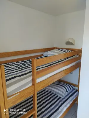 Un ou plusieurs lits dans un hébergement de l'établissement Location appartement meublé bord de mer