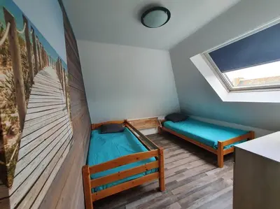 Un ou plusieurs lits dans un hébergement de l'établissement Charmant appartement proche commerces et plages