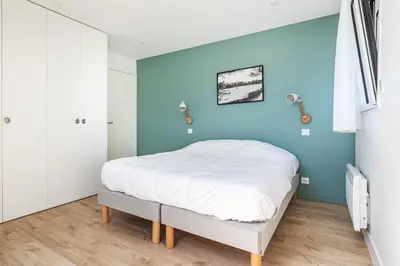 Un ou plusieurs lits dans un hébergement de l'établissement Les Peupliers - maison de vacances avec jardin