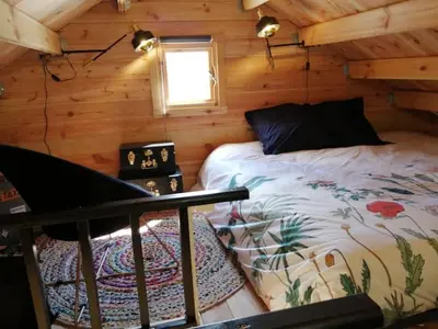 Un ou plusieurs lits dans un hébergement de l'établissement Lodge Domaine de Kerolivier