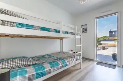 Un ou plusieurs lits dans un hébergement de l'établissement La Villa d'Ezer - Maison contemporaine 4-6 pers
