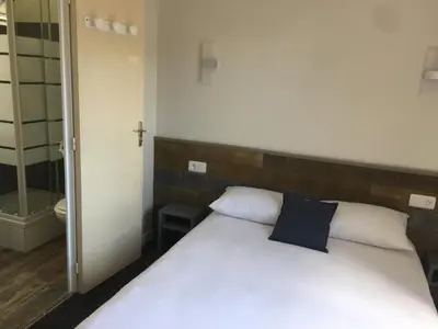 Un ou plusieurs lits dans un hébergement de l'établissement Hotel TGV