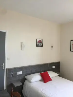 Un ou plusieurs lits dans un hébergement de l'établissement Hotel TGV