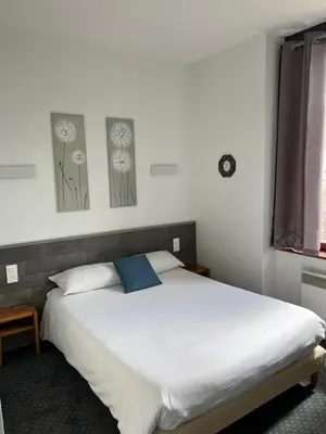 Un ou plusieurs lits dans un hébergement de l'établissement Hotel TGV