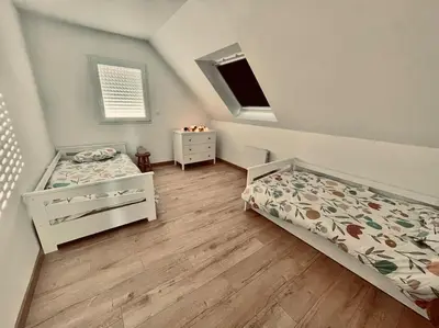 Un ou plusieurs lits dans un hébergement de l'établissement Maison à l'orée du bois du Kador