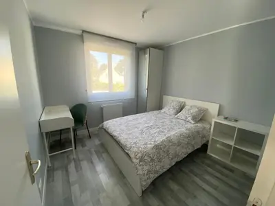 Un ou plusieurs lits dans un hébergement de l'établissement Chambre chez Marjorie