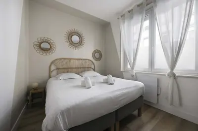 Un ou plusieurs lits dans un hébergement de l'établissement Appartement cozy au centre-ville