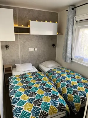Un ou plusieurs lits dans un hébergement de l'établissement Mobilhome bora bora